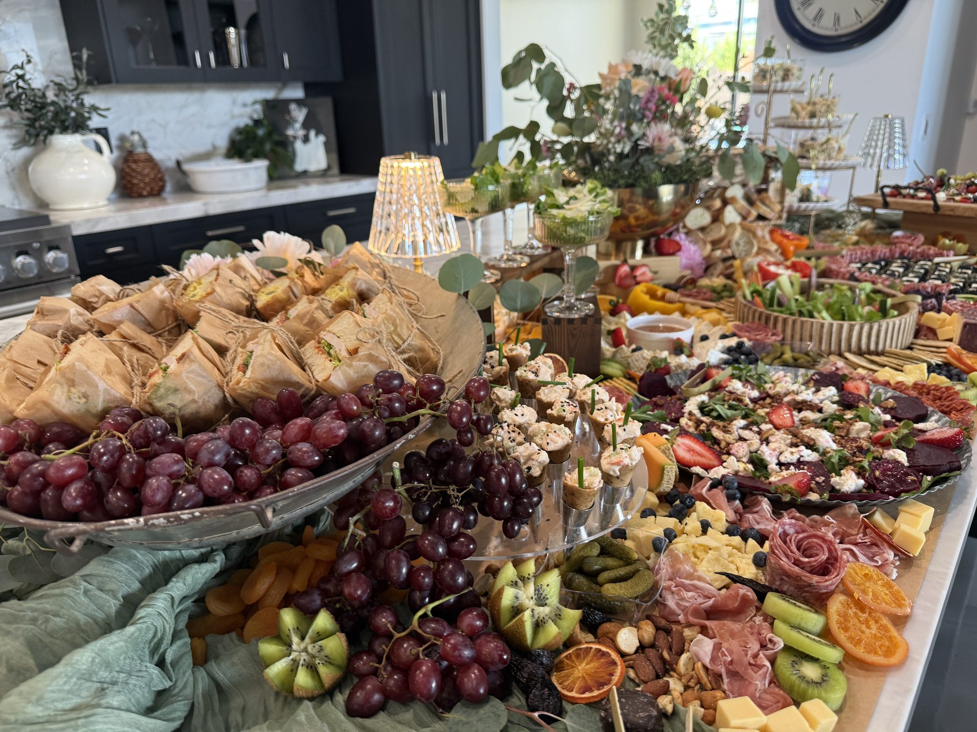 Grazing table with grapes, fruit, and charcuterie