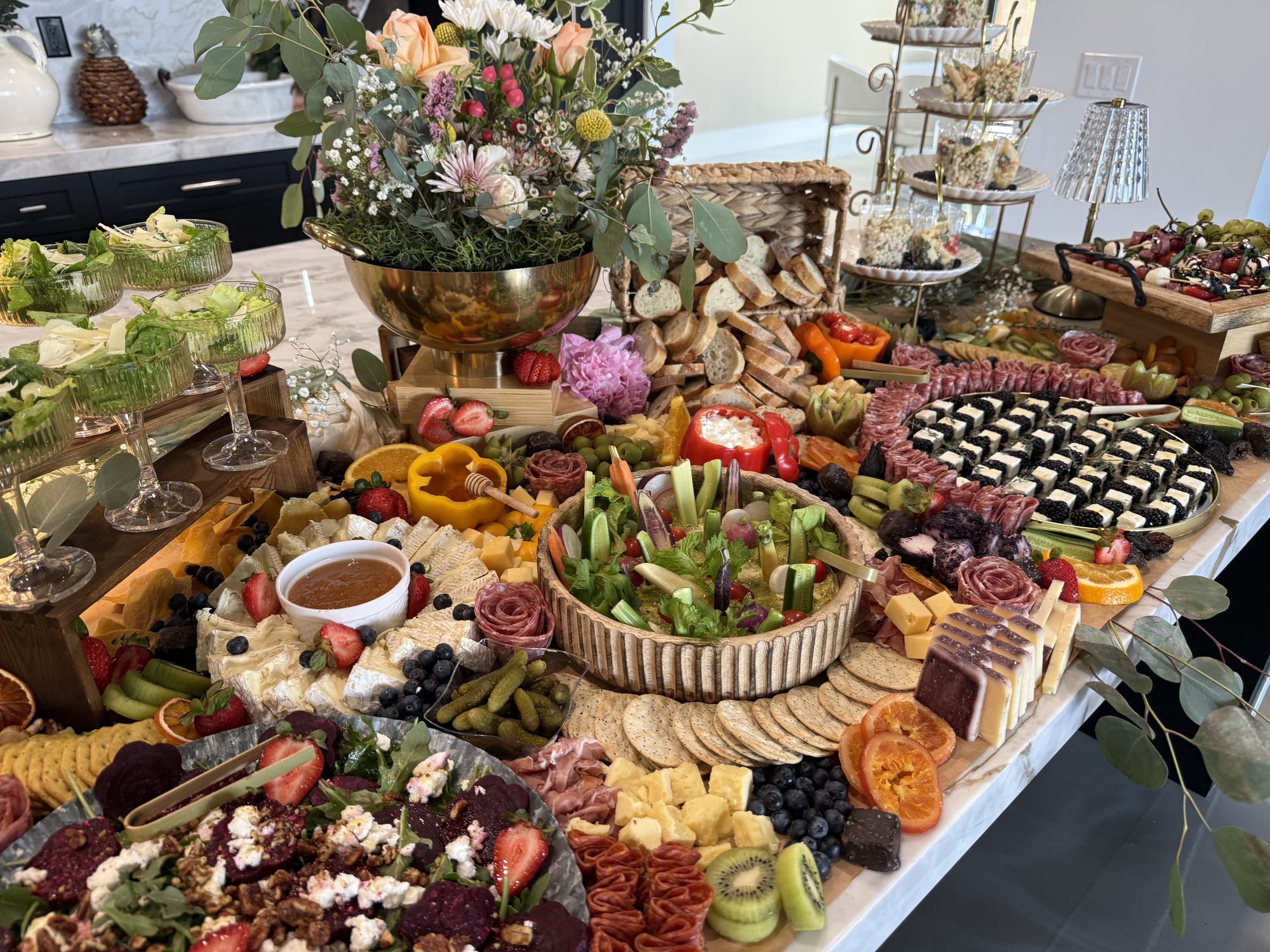 A full grazing table styled with florals, charcuterie, and champagne
