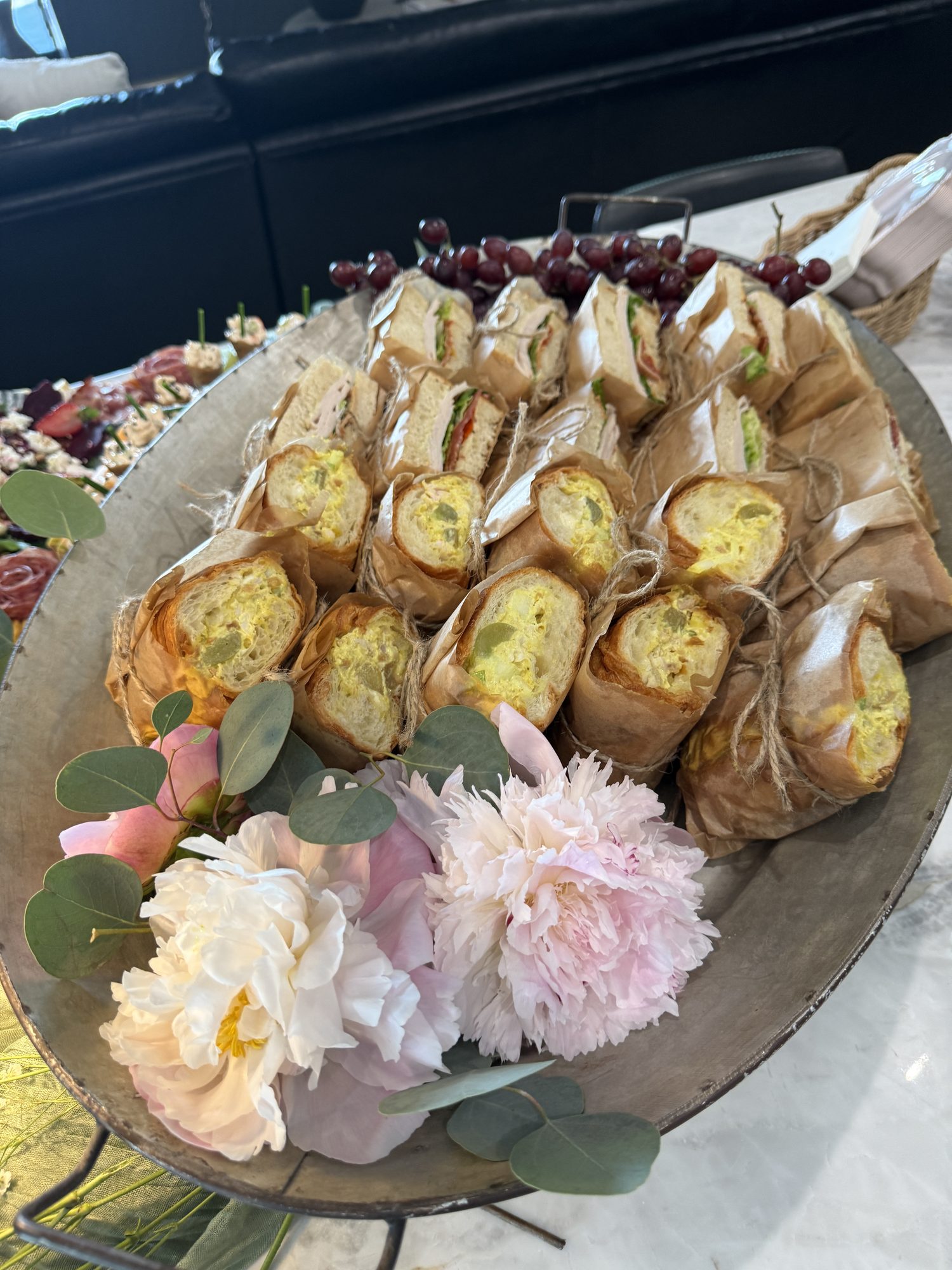 Artisan sandwich platter finished with peonies